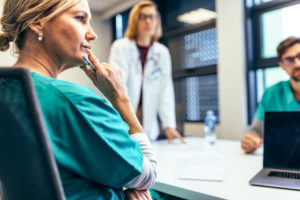 A female medical professional listening in a meeting