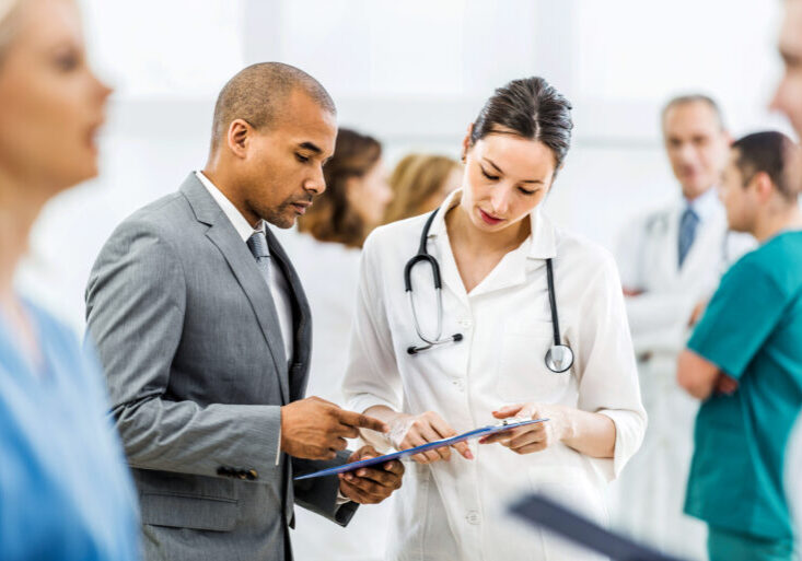 Young female doctor and African American businessman working together.
