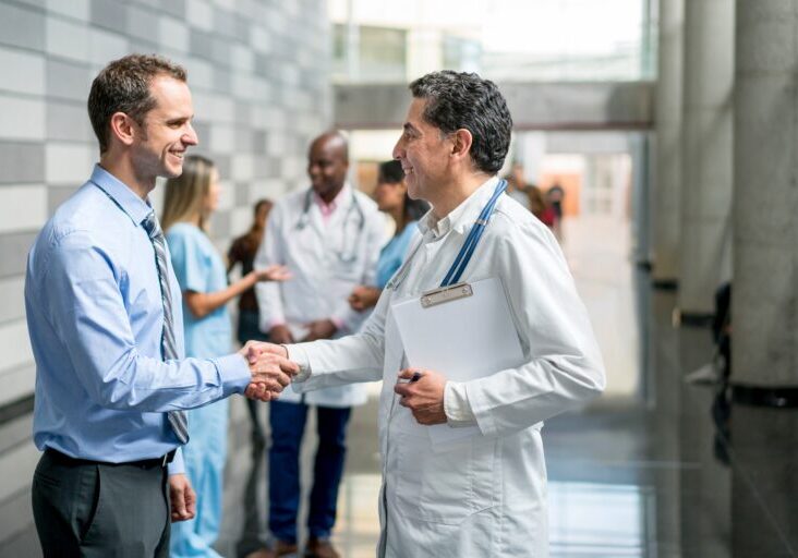 Handshake of a doctor and a businessman closing a deal